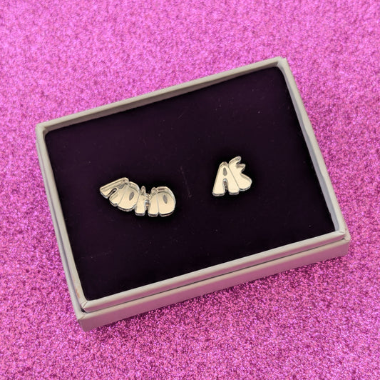 Small Silver ADHD AF stud earrings boxed on a pink glittery background