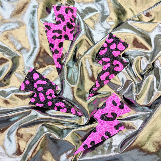 Large leopard print lightning bolt earrings in pink and black glitter