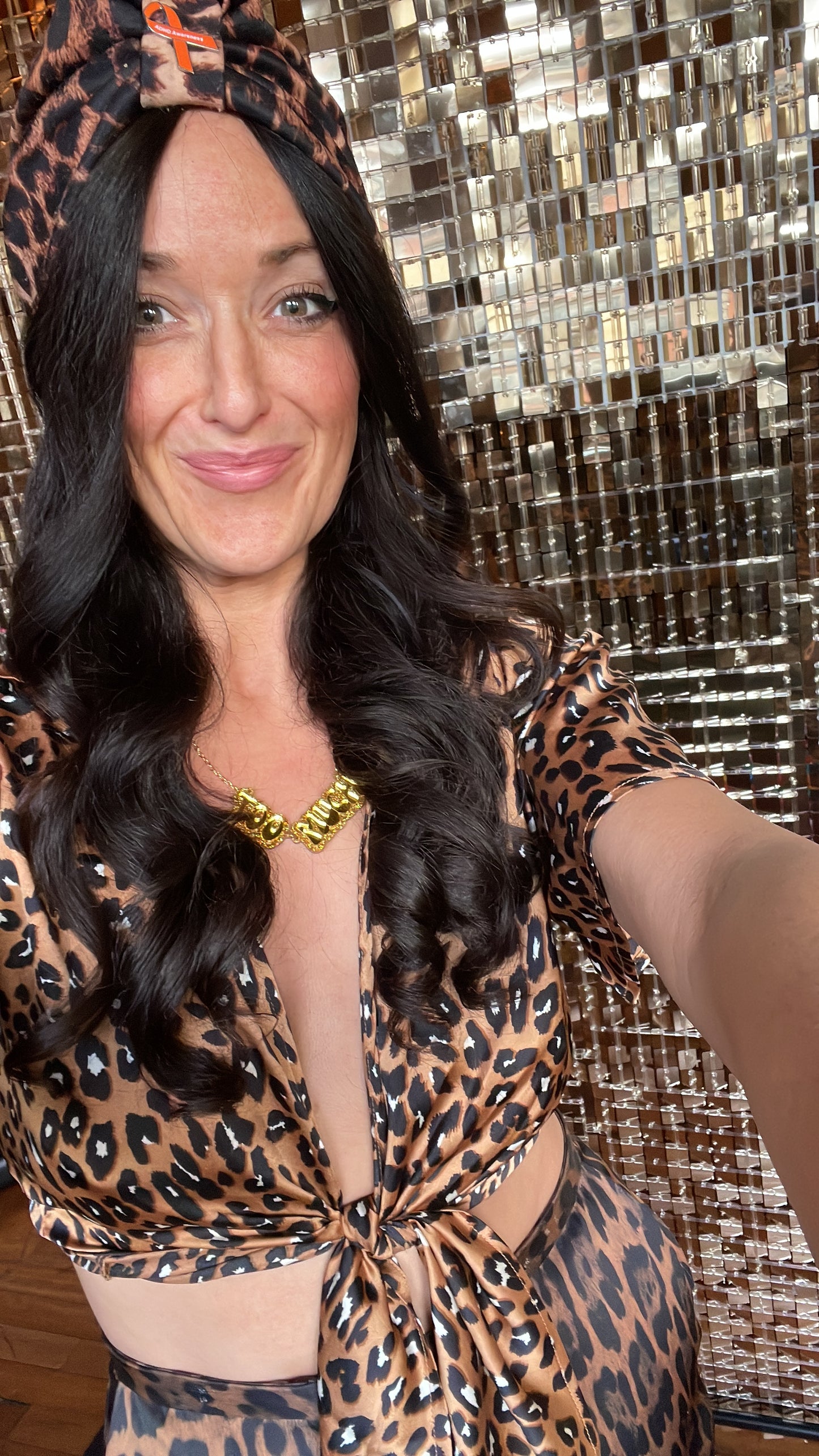 Model dressed in Leopard print wears gold too much necklace